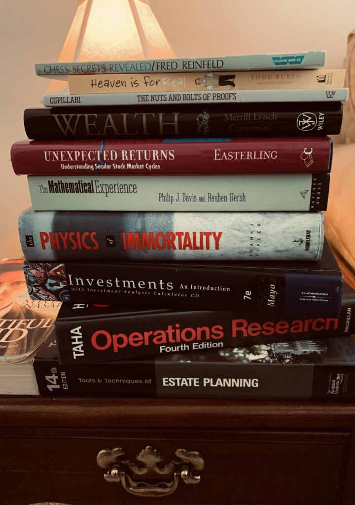 Stacks of books on a wooden table